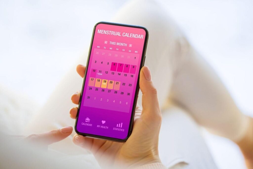 A woman tracking her period symptoms on her phone.