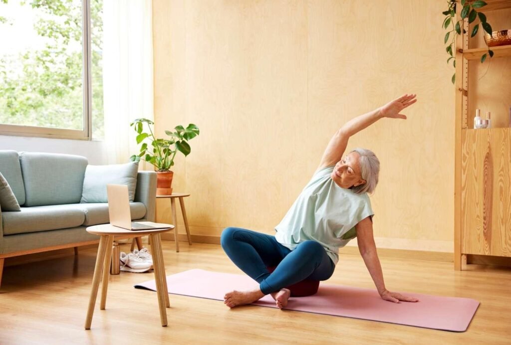 A woman practicing self-care at home, stretching gently on a yoga mat.
